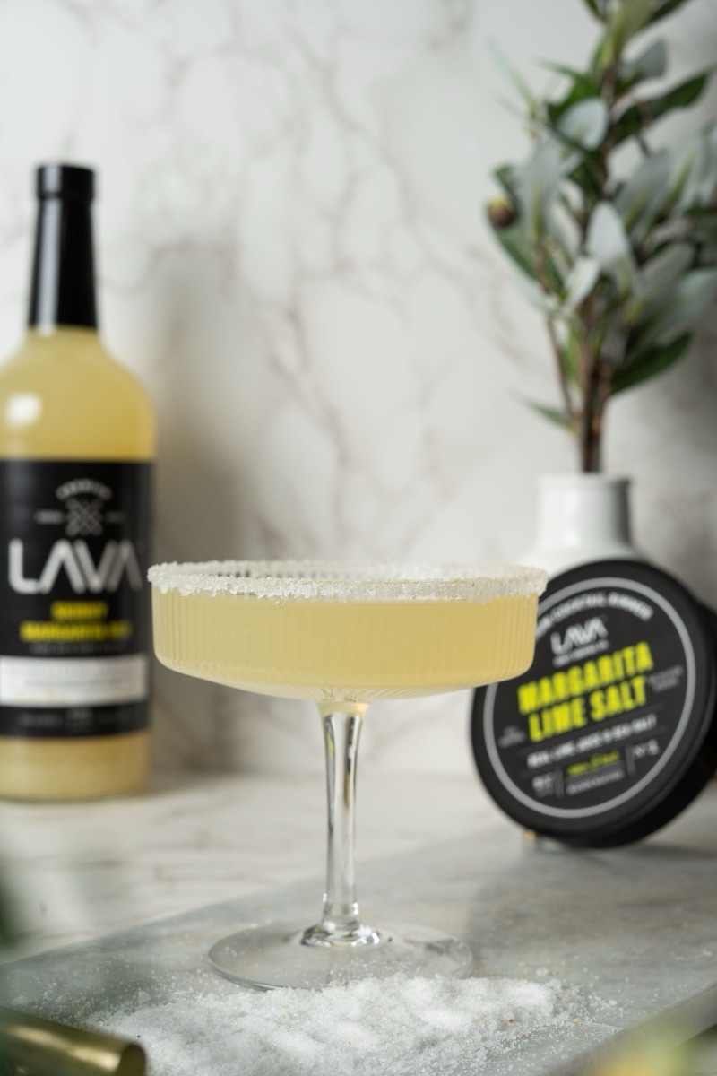 A classic margarita with a salted rim and a wheel of lime.