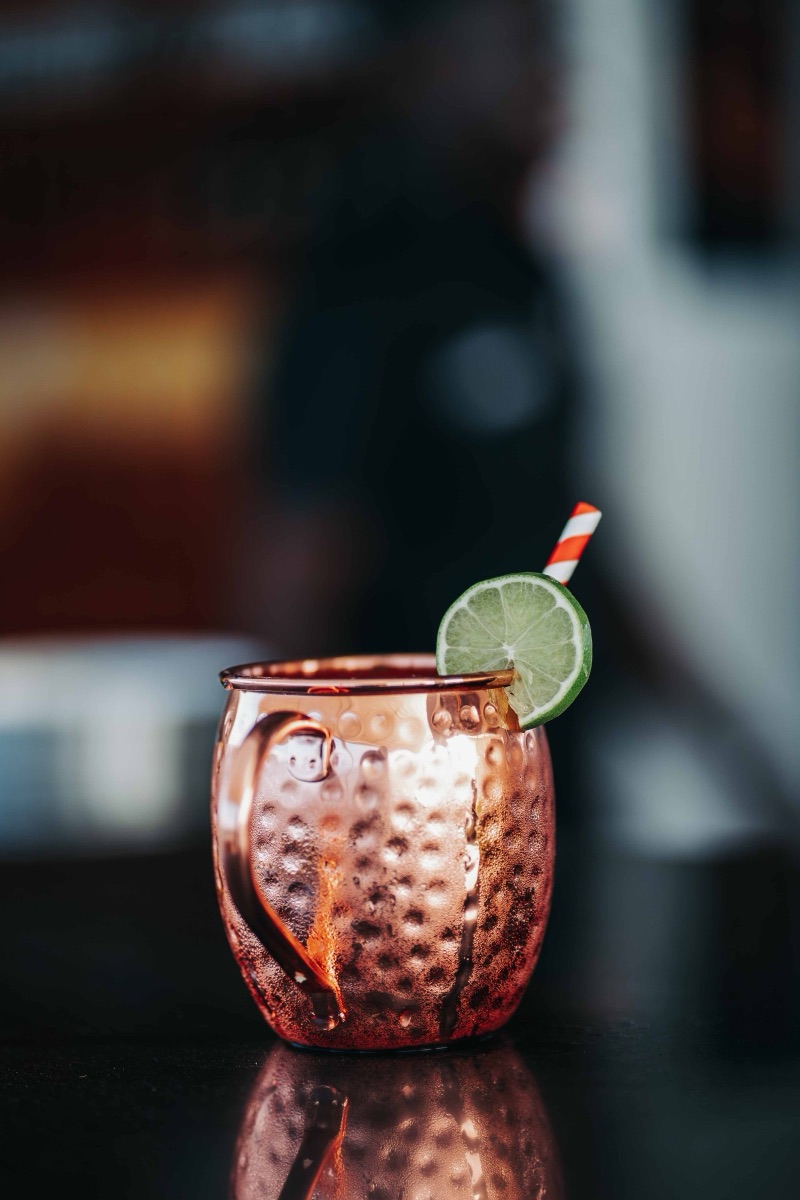 A Moscow mule in a copper mug with crushed ice and a wedge of lime.